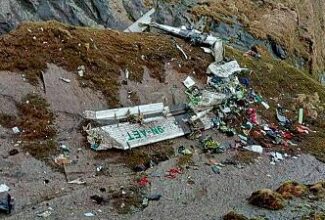 Rescuers pull bodies from plane wreckage scattered across a mountain gorge in Nepal